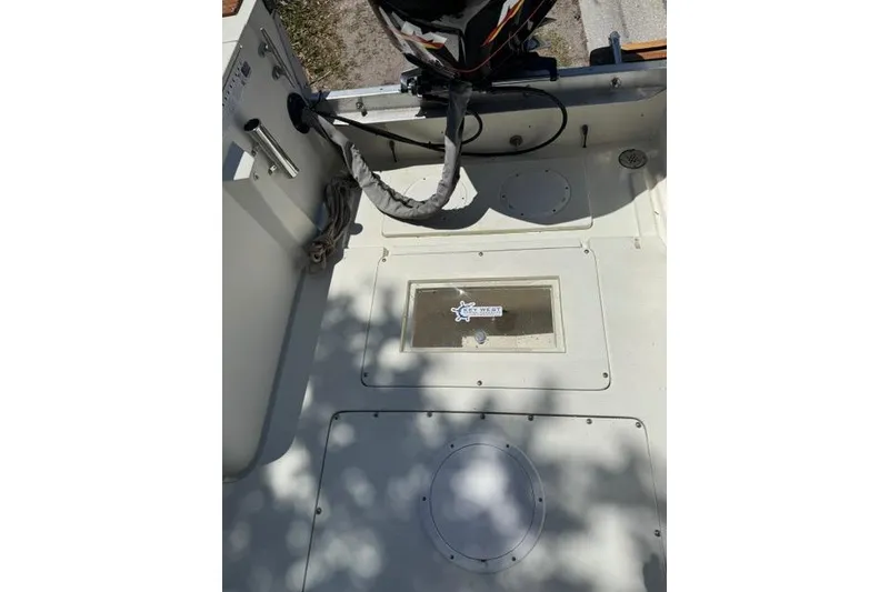 Slide: The Image of 1987 Mako 232 Center Console boat interior with motor and storage compartments. - 6