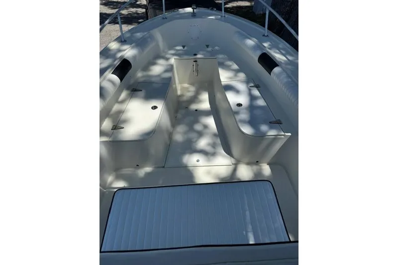 Slide: The Image of 1987 Mako 232 Center Console boat interior with seating and storage compartments. - 7