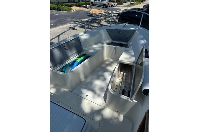 Slide: The Image of 1987 Mako 232 Center Console boat interior with open storage compartments. - 9