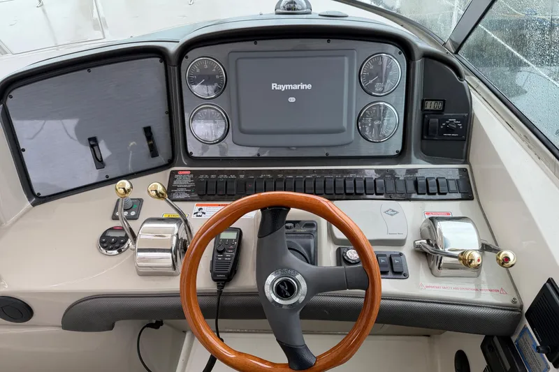Slide: The Image of Helm of 2006 Sea Ray 38 Sundancer with Raymarine display and wooden steering wheel. - 12