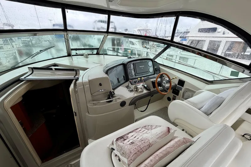 Slide: The Image of 2006 Sea Ray 38 Sundancer helm with modern controls and comfortable seating. - 15