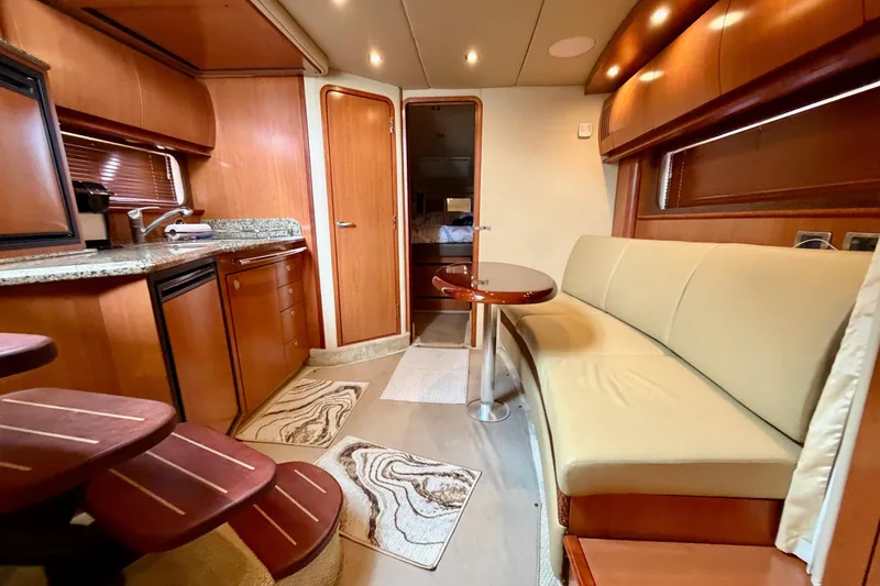 Slide: The Image of Luxurious interior of 2006 Sea Ray 38 Sundancer yacht with modern kitchen and seating area. - 17