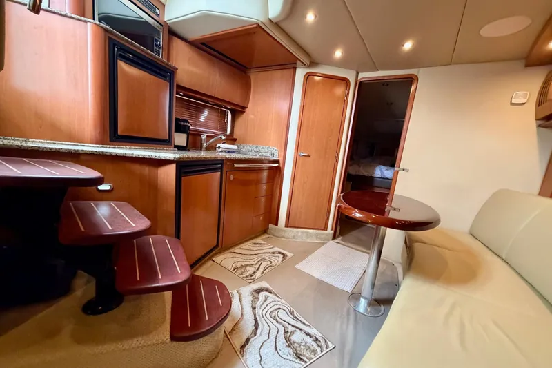 Slide: The Image of Luxurious interior of 2006 Sea Ray 38 Sundancer yacht with modern kitchen and seating area. - 18