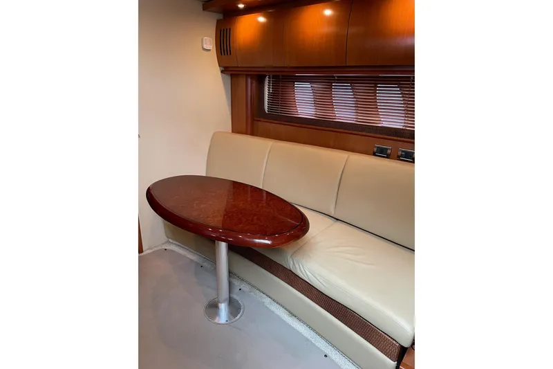 Slide: The Image of Interior of 2006 Sea Ray 38 Sundancer with beige seating and wooden table. - 19