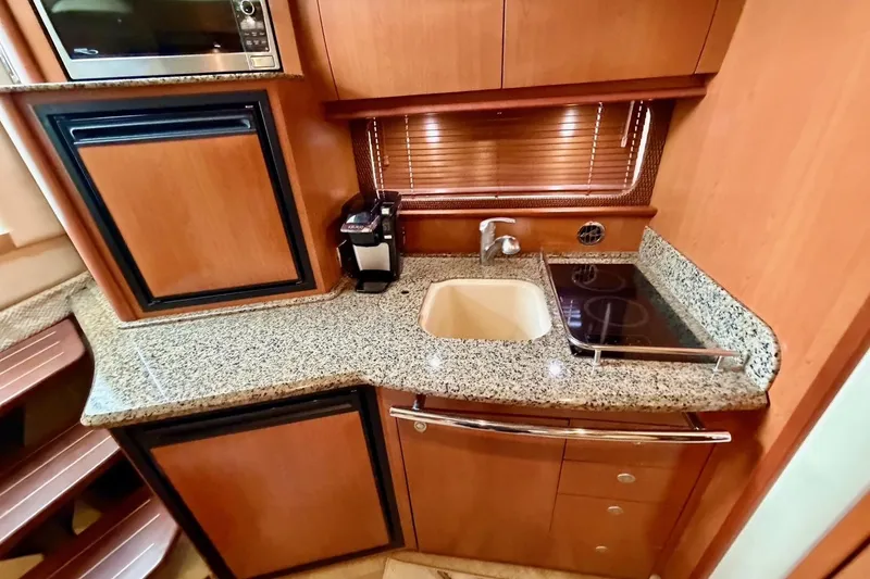 Slide: The Image of Luxurious 2006 Sea Ray 38 Sundancer yacht kitchen with granite countertops and modern appliances. - 21