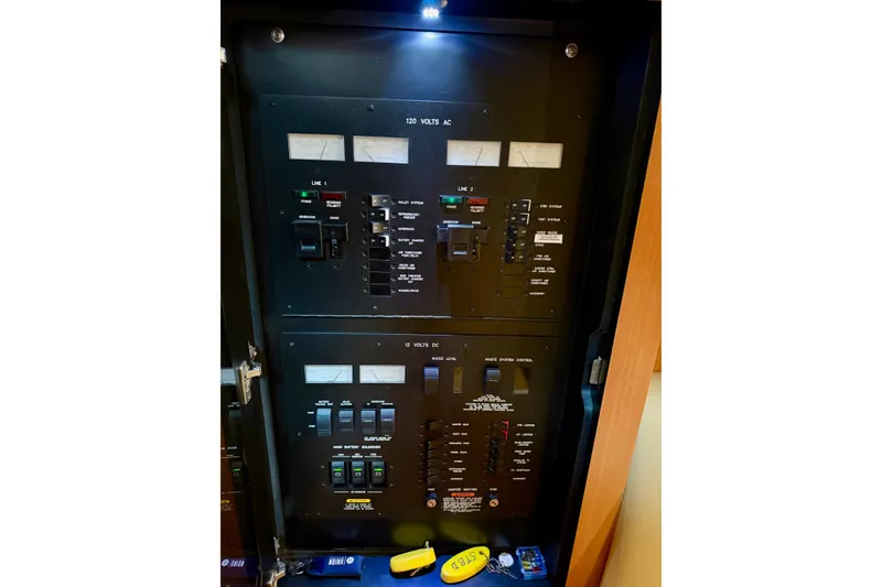 Slide: The Image of Electrical control panel of a 2006 Sea Ray 38 Sundancer boat, featuring switches and gauges. - 25
