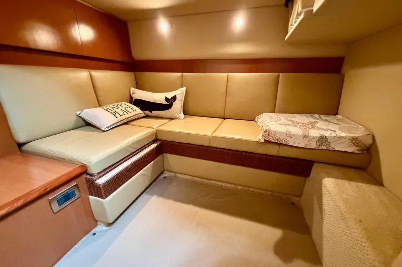 Slide: The Image of Interior of 2006 Sea Ray 38 Sundancer with beige seating and decorative pillows. - 26