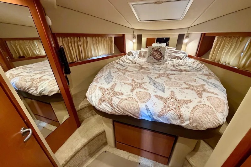 Slide: The Image of Luxurious cabin interior of 2006 Sea Ray 38 Sundancer with starfish-themed bedding. - 29