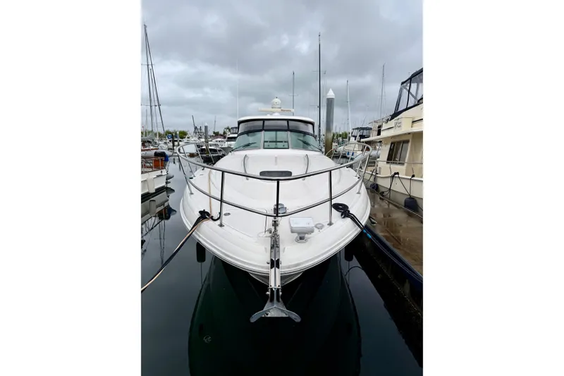 Slide: The Image of 2006 Sea Ray 38 Sundancer yacht docked at marina under cloudy skies. - 3