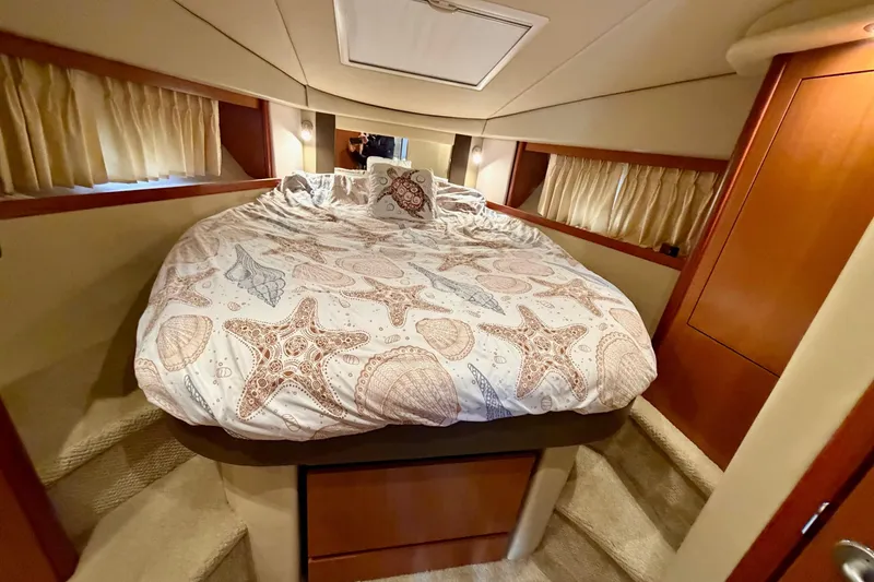Slide: The Image of Luxurious cabin interior of 2006 Sea Ray 38 Sundancer with starfish-themed bedding. - 30