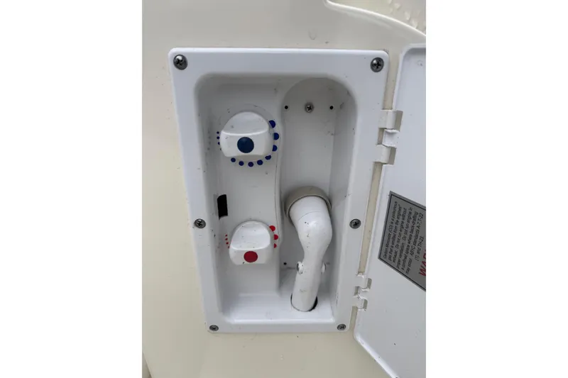 Slide: The Image of Boat shower controls on a 2006 Sea Ray 38 Sundancer, featuring temperature adjustment knobs. - 34