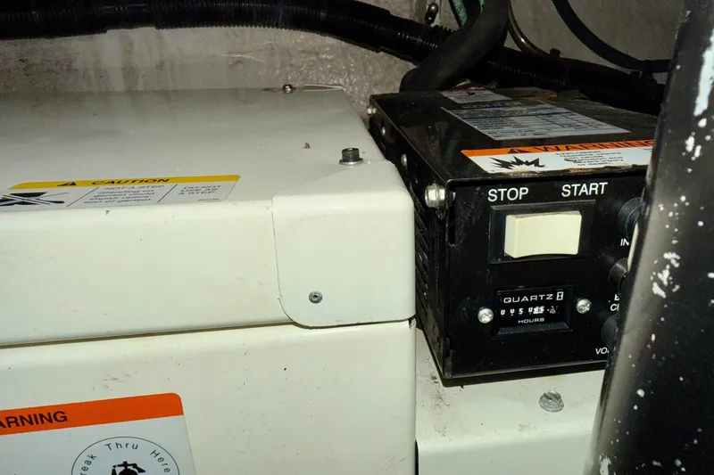 Slide: The Image of Control panel of a 2006 Sea Ray 38 Sundancer boat with start and stop buttons. - 42