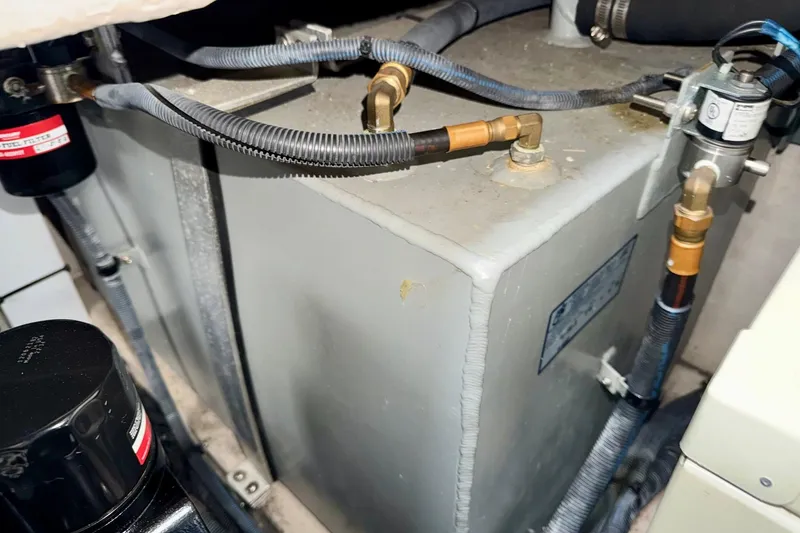 Slide: The Image of Engine compartment of a 2006 Sea Ray 38 Sundancer with visible fuel lines and components. - 43
