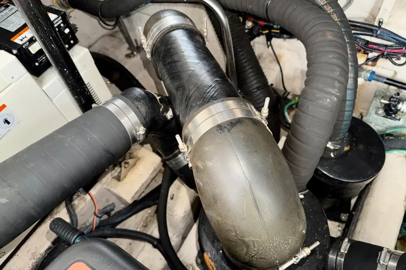 Slide: The Image of Engine compartment of a 2006 Sea Ray 38 Sundancer with visible hoses and clamps. - 44
