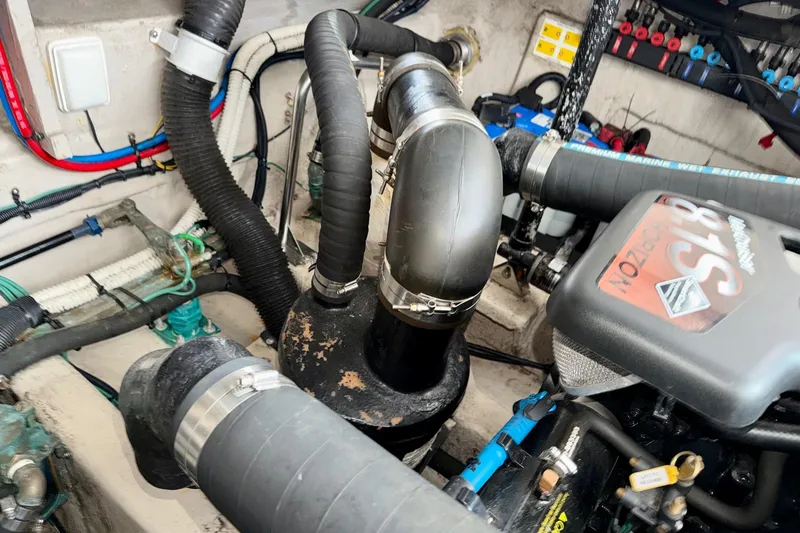 Slide: The Image of Engine compartment of a 2006 Sea Ray 38 Sundancer with visible hoses and components. - 45