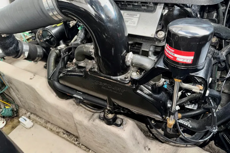 Slide: The Image of Engine compartment of a 2006 Sea Ray 38 Sundancer boat, featuring a Mercury engine. - 46