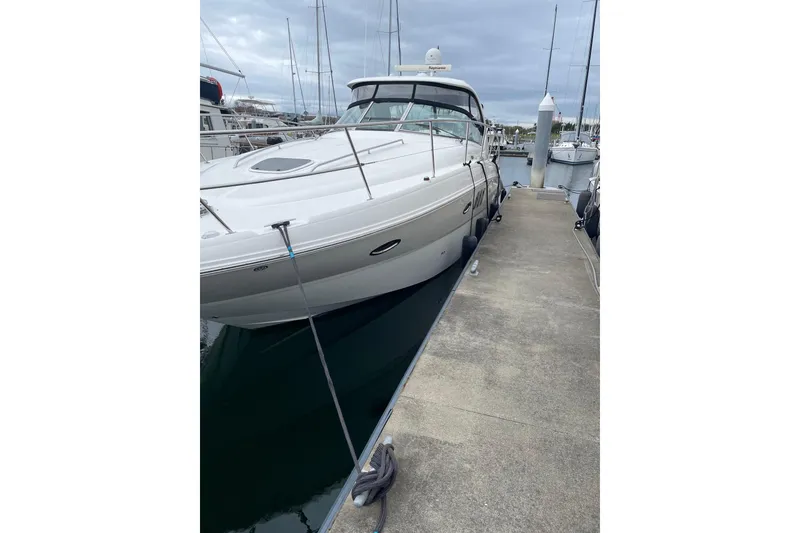 Slide: The Image of 2006 Sea Ray 38 Sundancer yacht docked at marina, overcast sky. - 48