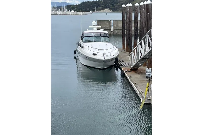 Slide: The Image of 2006 Sea Ray 38 Sundancer yacht docked at marina, calm water, overcast sky. - 50