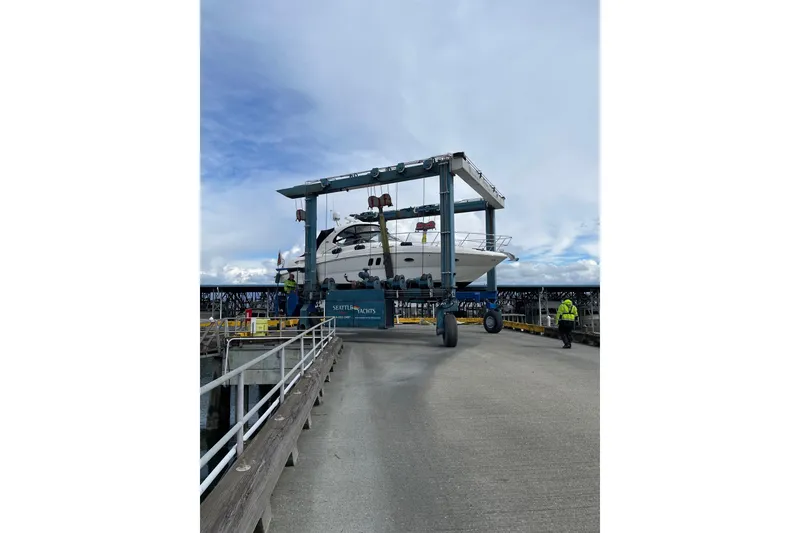 Slide: The Image of 2006 Sea Ray 38 Sundancer yacht being lifted at Seattle Yachts marina. - 52