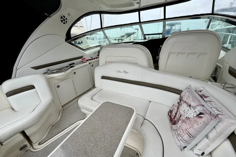 Slide: The Image of Interior of 2006 Sea Ray 38 Sundancer yacht with white seating and nautical decor. - 8
