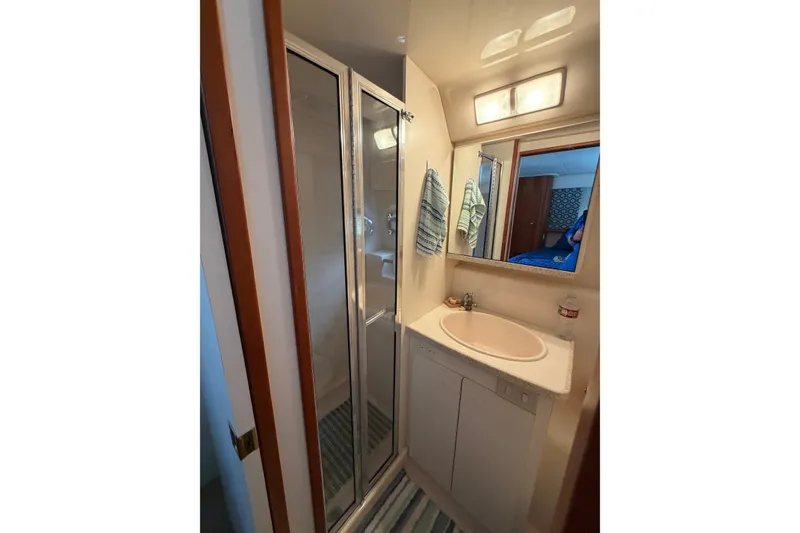 Slide: The Image of Bathroom interior of 1999 Silverton 352 Motor Yacht with shower and sink. - 27