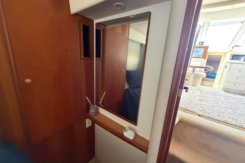 Slide: The Image of 1999 Silverton 352 Motor Yacht interior with mirror and wooden cabinetry. - 29