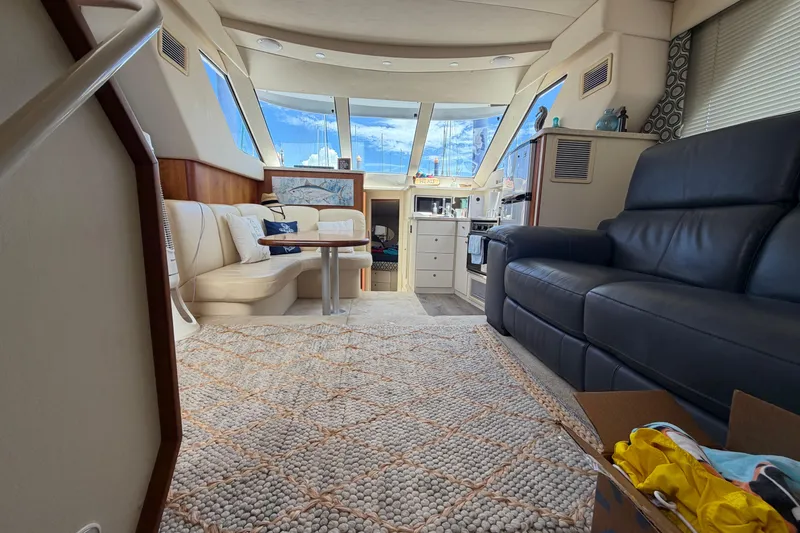 Slide: The Image of Interior of a 1999 Silverton 352 Motor Yacht with cozy seating and nautical decor. - 30