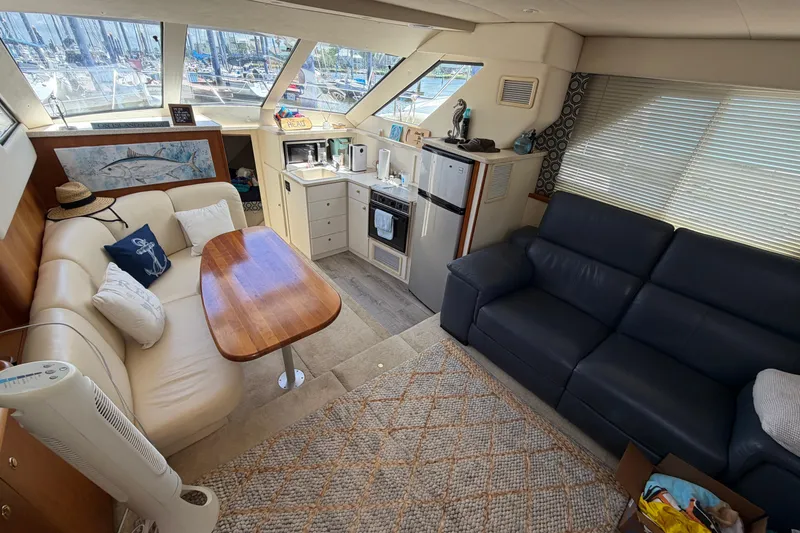 Slide: The Image of Interior of 1999 Silverton 352 Motor Yacht with cozy seating and kitchenette. - 33
