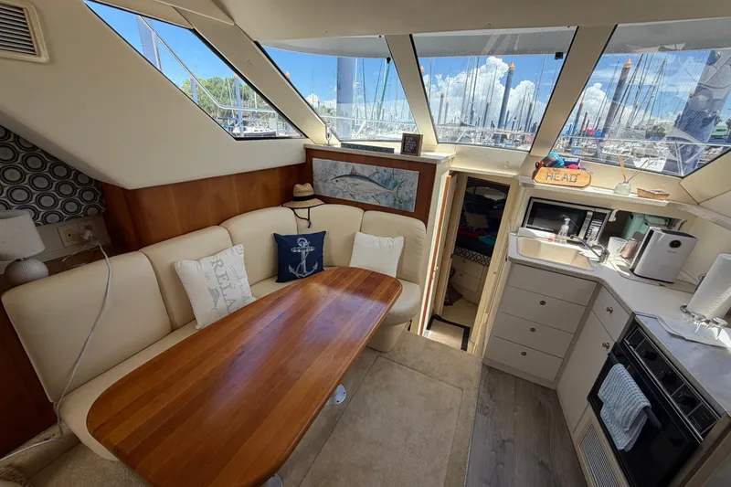 Slide: The Image of Interior of 1999 Silverton 352 Motor Yacht with cozy seating and kitchenette. - 34