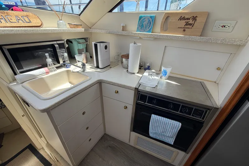 Slide: The Image of Compact kitchen in a 1999 Silverton 352 Motor Yacht with modern appliances. - 37