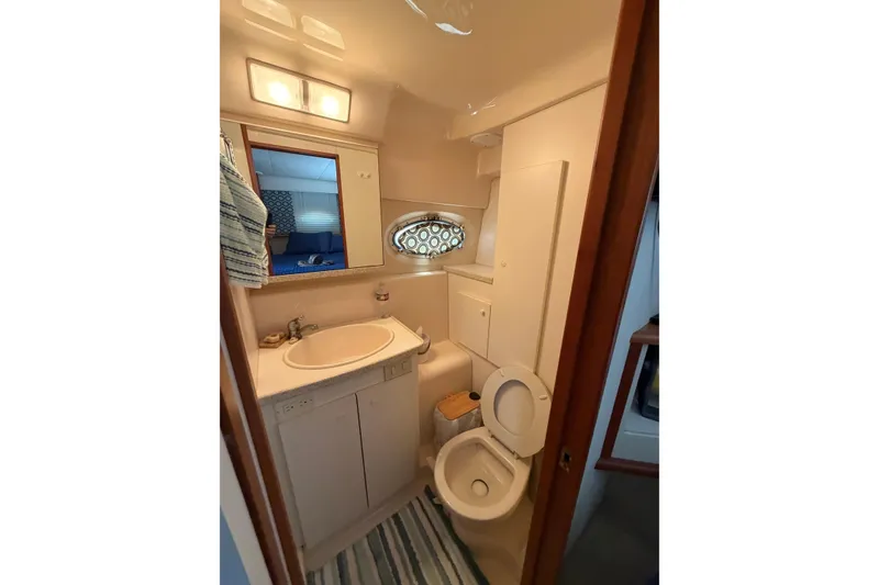 Slide: The Image of Bathroom interior of 1999 Silverton 352 Motor Yacht with sink, toilet, and mirror. - 41