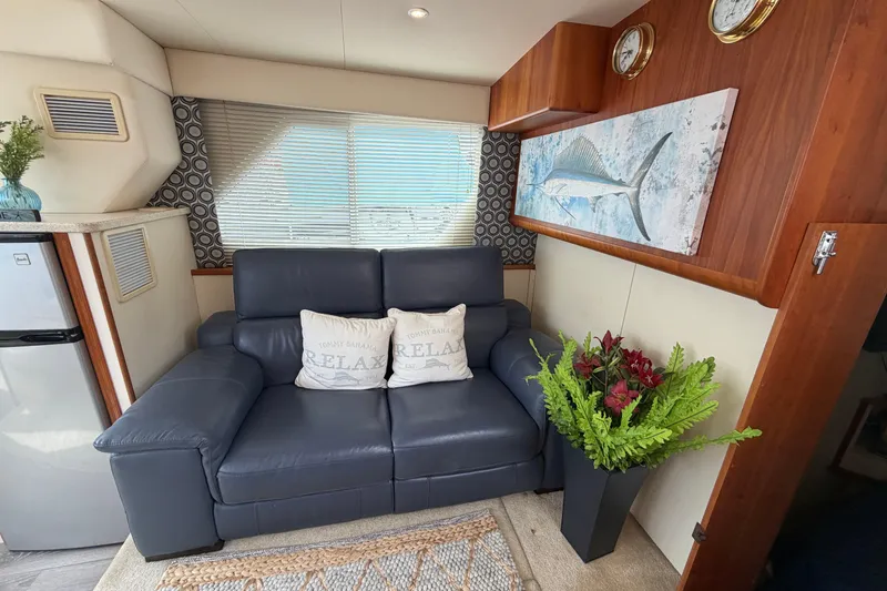 Slide: The Image of Luxurious interior of 1999 Silverton 352 Motor Yacht with leather sofa and marine decor. - 49