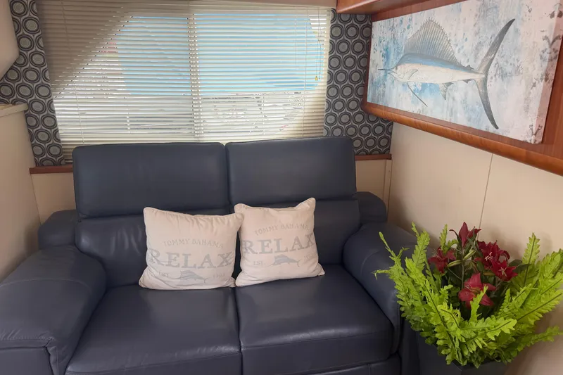 Slide: The Image of Interior of 1999 Silverton 352 Motor Yacht with blue sofa, decorative pillows, and artwork. - 50