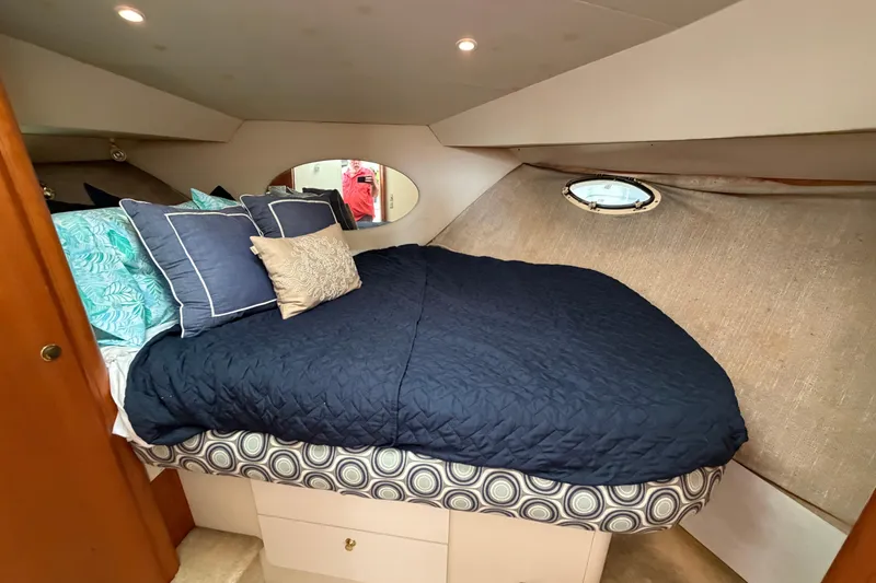 Slide: The Image of Cozy bedroom in 1999 Silverton 352 Motor Yacht with plush bedding and porthole window. - 54