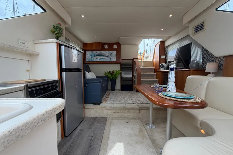 Slide: The Image of Interior of a 1999 Silverton 352 Motor Yacht with modern amenities and elegant decor. - 56