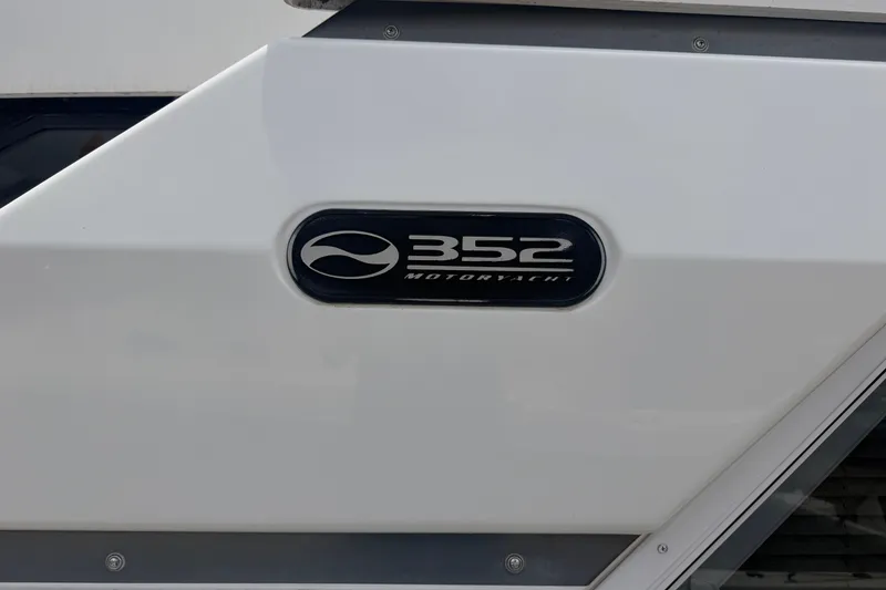 Slide: The Image of 1999 Silverton 352 Motor Yacht emblem on white hull, showcasing sleek design. - 6