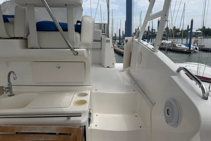 Slide: The Image of 1999 Silverton 352 Motor Yacht interior with seating, sink, and marina view. - 8
