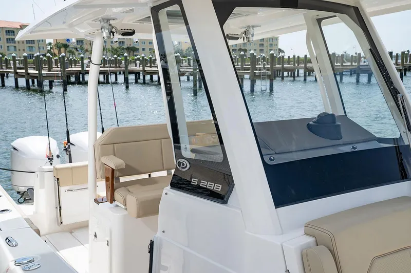 Slide: The Image of Manufacturer Provided Image: 2025 Pursuit S 288 Sport boat docked, featuring sleek design and comfortable seating. - 12