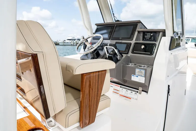 Slide: The Image of Manufacturer Provided Image: 2025 Pursuit S 288 Sport boat interior with helm and seating, featuring modern design. - 13