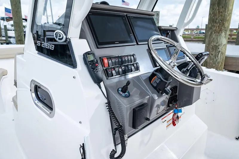 Slide: The Image of Manufacturer Provided Image: 2025 Pursuit S 288 Sport boat dashboard with steering wheel and control panel. - 14