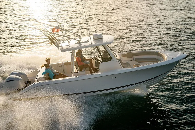 Slide: The Image of Manufacturer Provided Image: 2025 Pursuit S 288 Sport boat cruising on open water at sunset. - 2