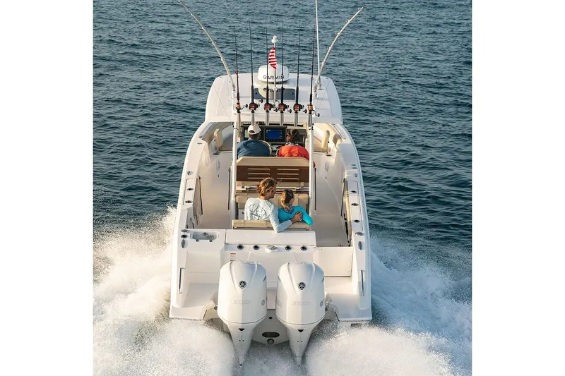 Slide: The Image of Manufacturer Provided Image: 2025 Pursuit S 288 Sport boat cruising on open water, rear view. - 5