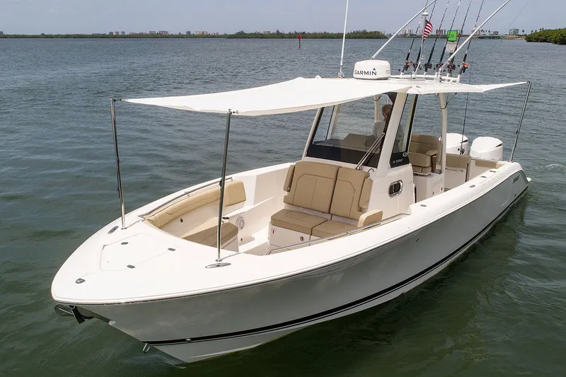 Slide: The Image of Manufacturer Provided Image: 2025 Pursuit S 288 Sport boat on calm water, featuring a sleek design and fishing equipment. - 8
