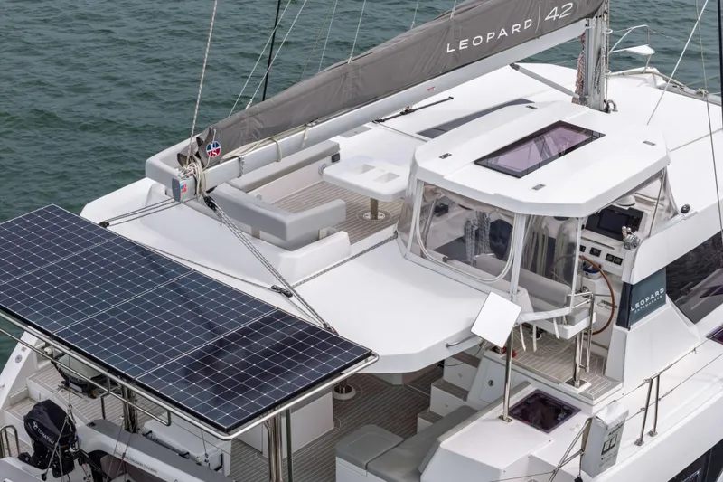 Slide: The Image of 2022 Leopard 42 catamaran with solar panels and spacious deck on the water. - 11
