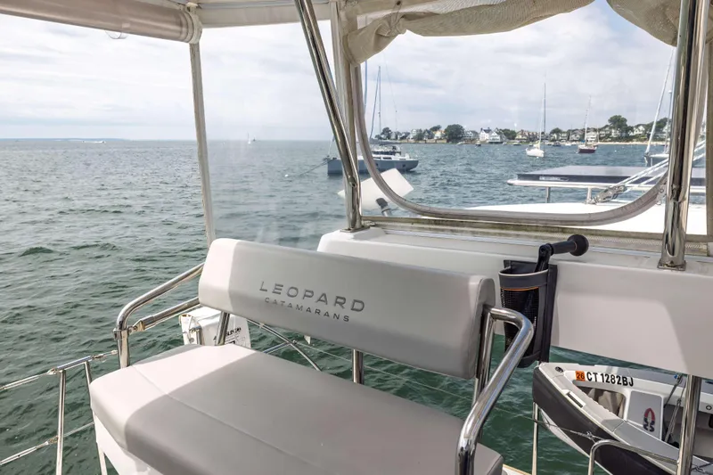 Slide: The Image of Leopard 42 catamaran helm view, showcasing ocean and distant shoreline, 2022 model. - 19