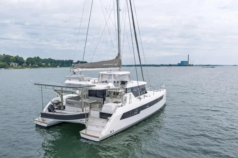 Slide: The Image of 2022 Leopard 42 catamaran sailing on a calm lake with distant shoreline. - 3