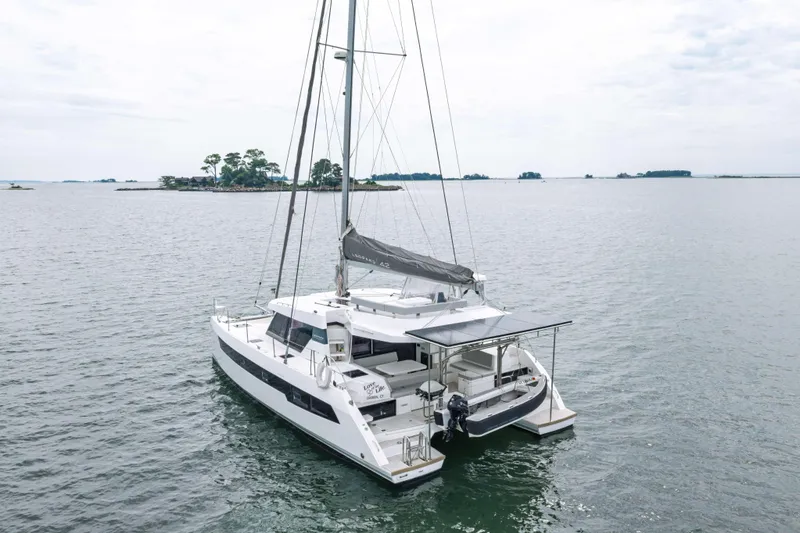 Slide: The Image of 2022 Leopard 42 catamaran sailing on calm waters near a small island. - 5
