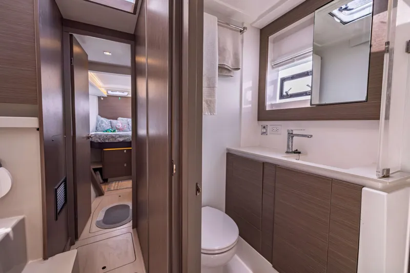 Slide: The Image of Modern bathroom interior on a 2022 Leopard 42 yacht, featuring sleek wood finishes and a compact design. - 50