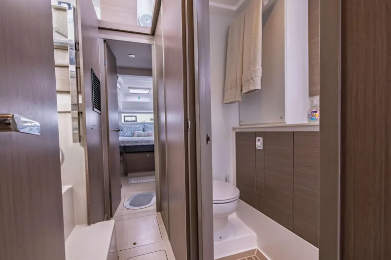 Slide: The Image of Modern bathroom interior on a 2022 Leopard 42 yacht, featuring sleek wood finishes. - 44