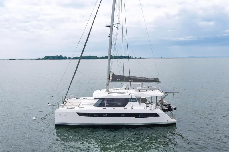 Slide: The Image of 2022 Leopard 42 catamaran sailing on calm waters under a cloudy sky. - 6